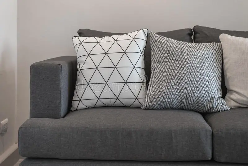 Graphic Pattern Pillows On Modern Grey Sofa Stock Photo